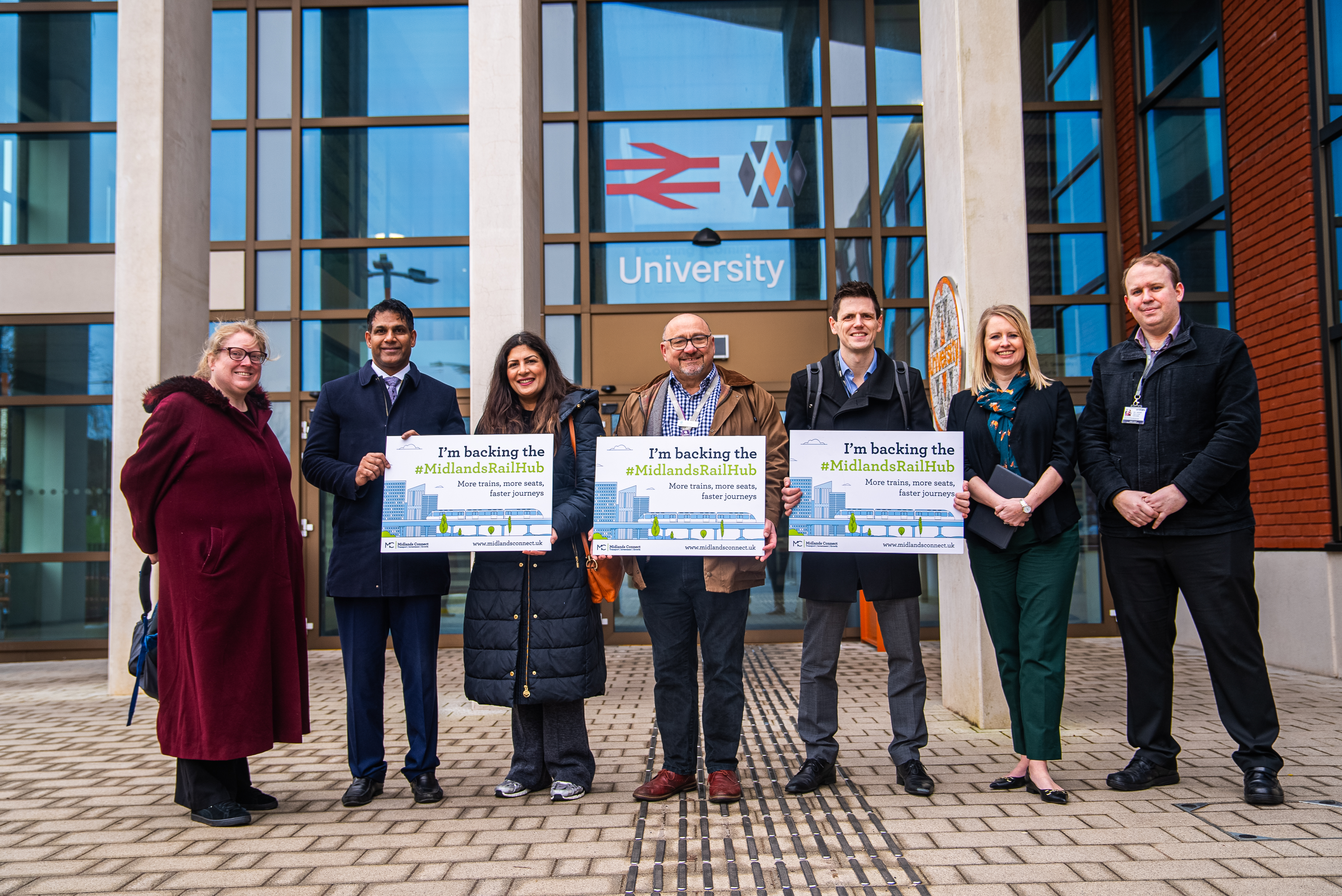 Line up of the MP and rail industry bosses outside the University Railway Station