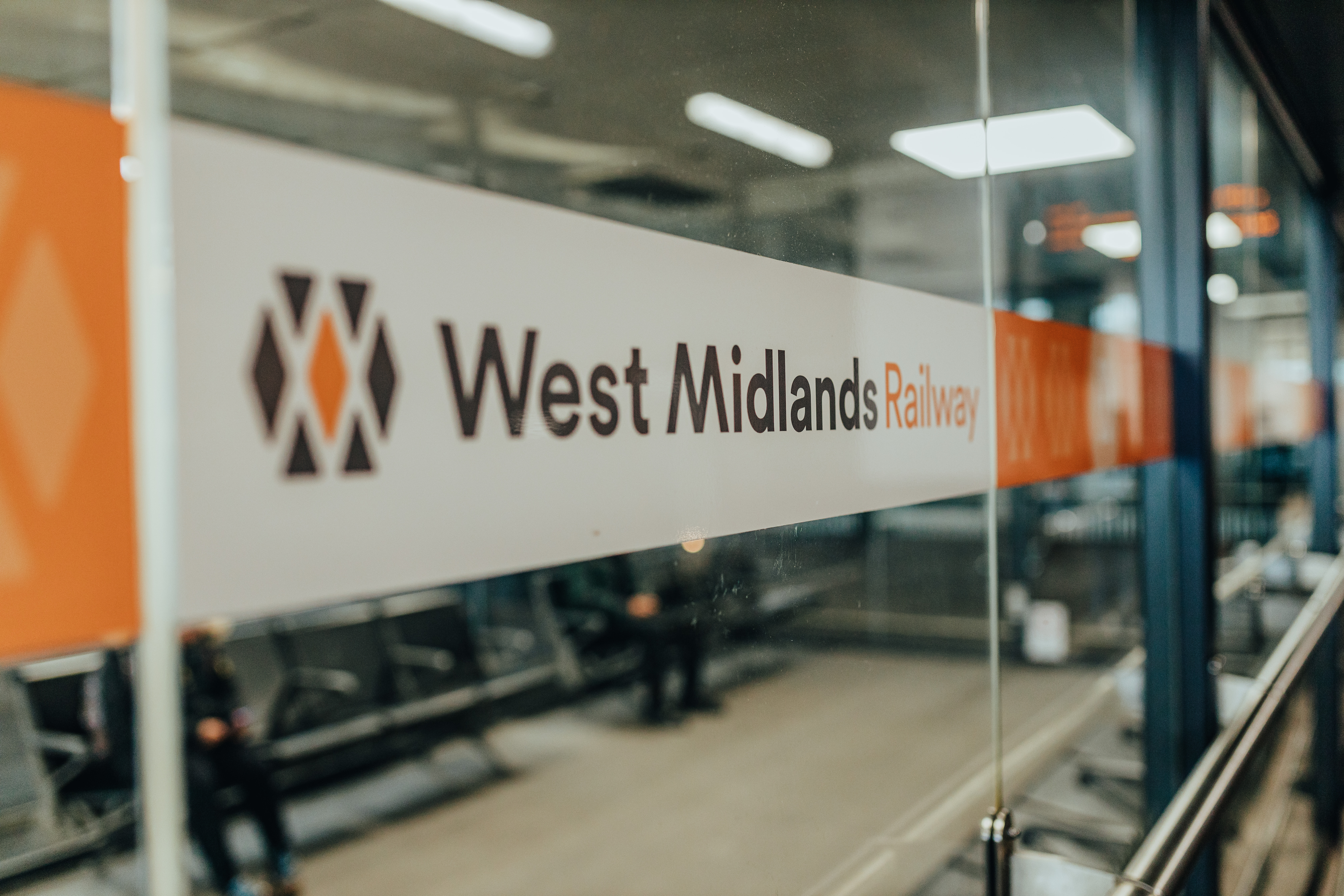 A West Midlands Railway banner on a window.