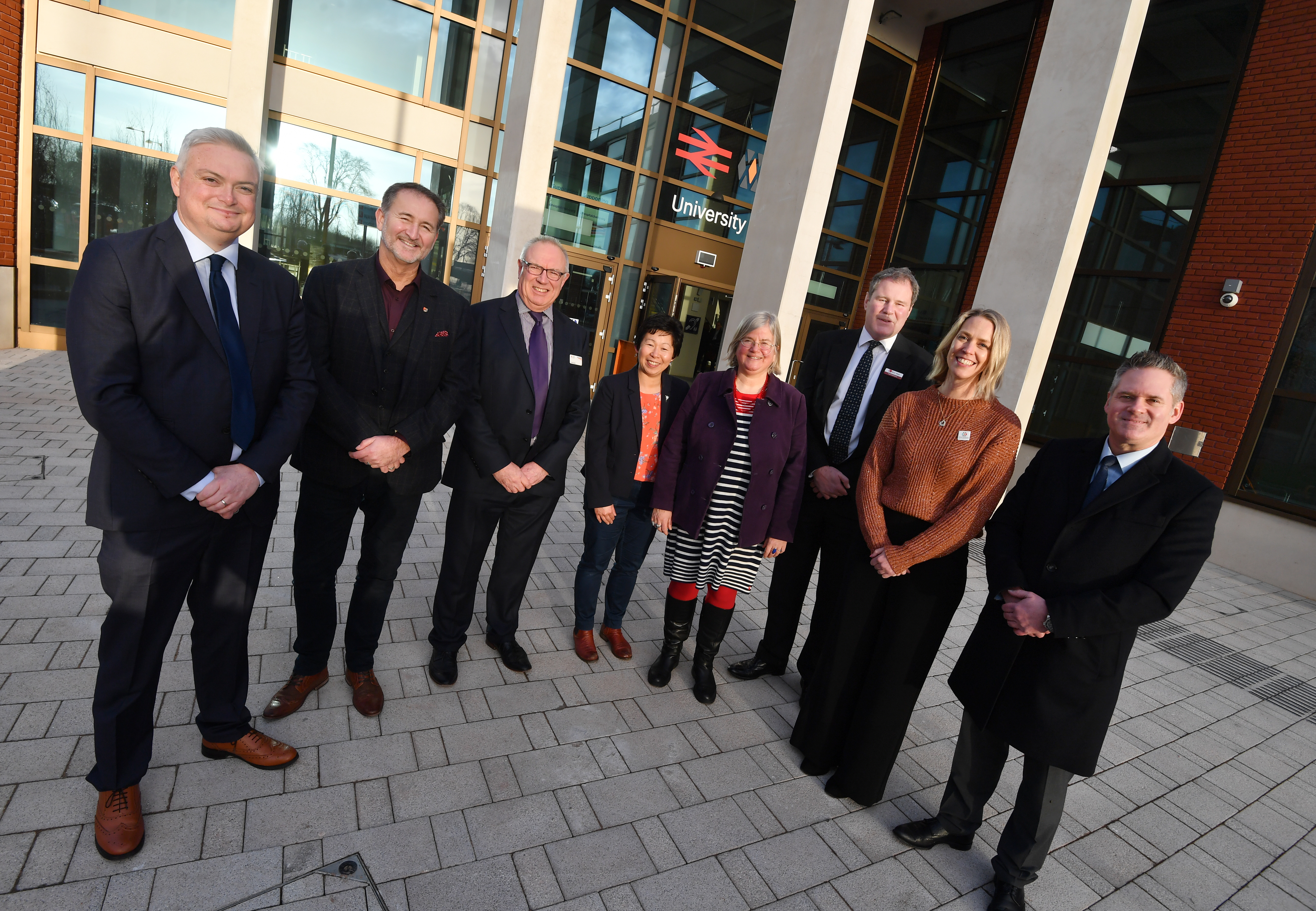 Representatives from some of the project partners standing outside the new University Railway Station